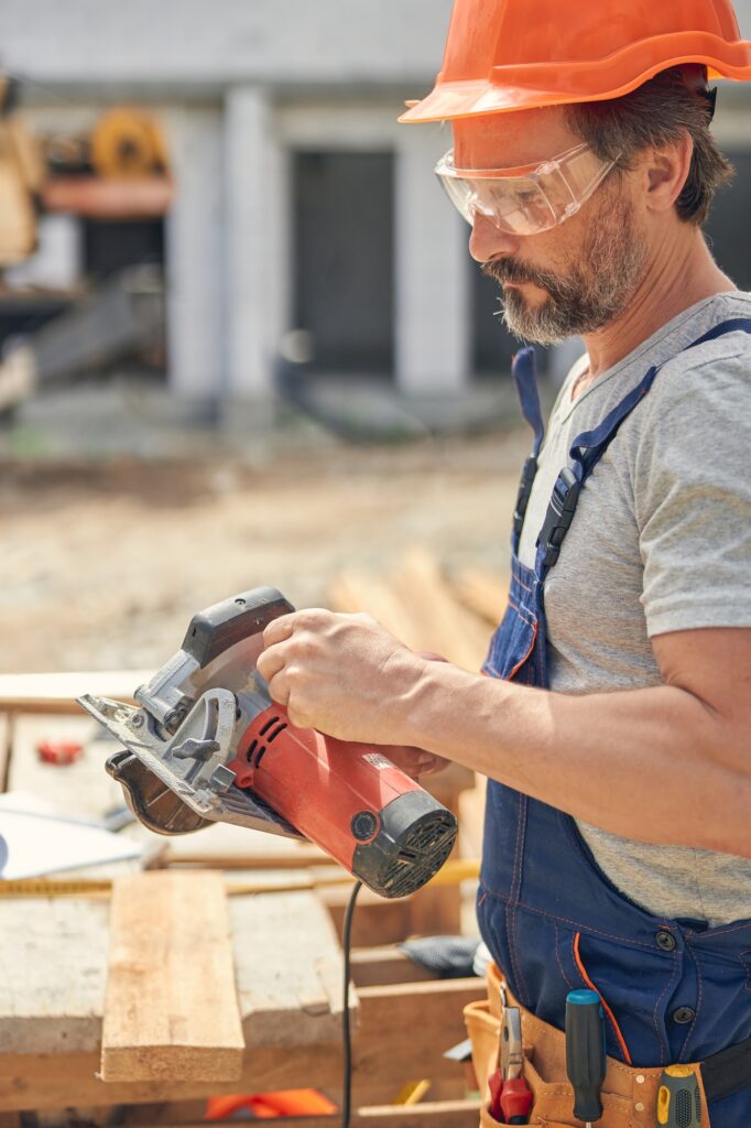 Focused carpenter getting ready for cutting wood